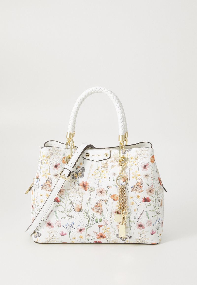 Sac à main blanc avec motif floral comportant des papillons, matériel doré, poignée tressée blanche et accent de chaîne détachable.