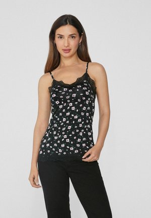 Camiseta de flores negra con encaje, con un diseño ajustado y tirantes ajustables, decorada con pequeñas flores en rosa y blanco.