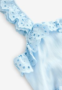 Lichtblauwe kleding met delicate kantafwerking en ronde uitsparingen, gladde textuur en een ruchesdesign op de banden.