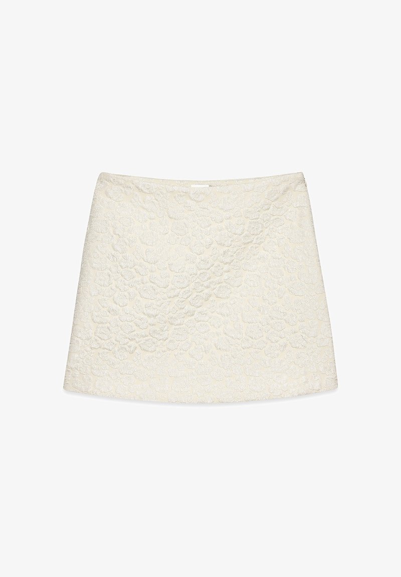 Jupe mini à motif floral blanc avec un tissu texturé, présentant une taille lisse et un design à coupe droite.