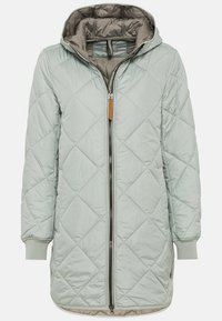 Veste matelassée vert clair avec capuche, munie d'une fermeture éclair centrale, de poignets côtelés et d'un doux revêtement intérieur. Design slim et allongé.