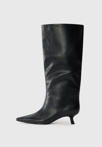 Black knee-high leather boot with pointed toe and low kitten heel, displayed on a plain light background.