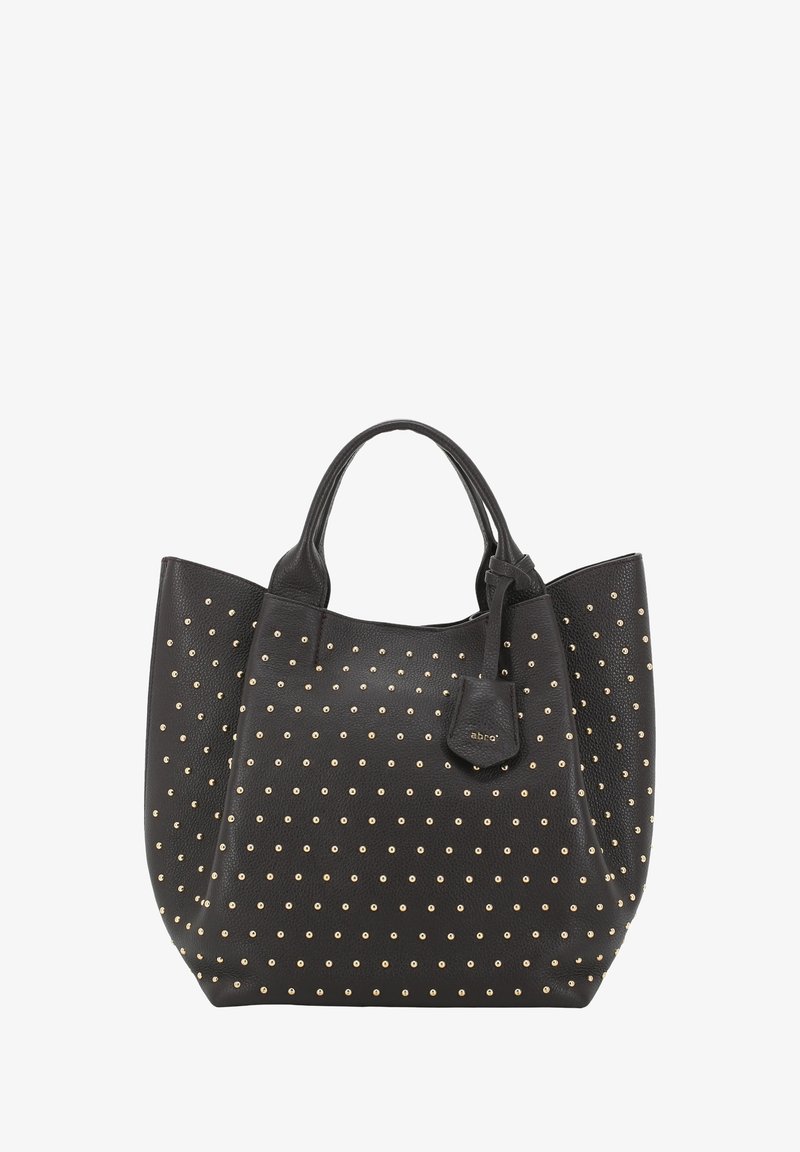 Black leather tote bag with gold studs, featuring rounded handles and a detachable tag. Smooth texture with a structured shape.