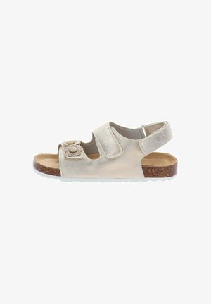 Sandalo beige per bambino con suola in sughero, due cinturini regolabili, di cui uno con applicazioni floreali, e cinturino posteriore per il supporto del tallone.