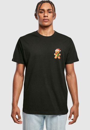 Black cotton t-shirt with a short sleeve and crew neck, featuring a colorful gingerbread cookie graphic on the left chest area.