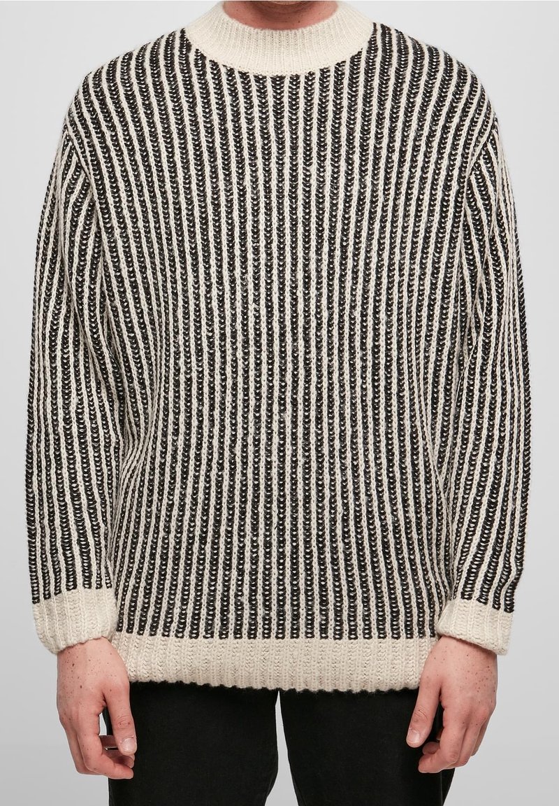 Strickpullover mit schwarzen und cremefarbenen vertikalen Streifen, geripptem Saum und Bündchen, Rundhalsausschnitt, strukturiertem Stoff.