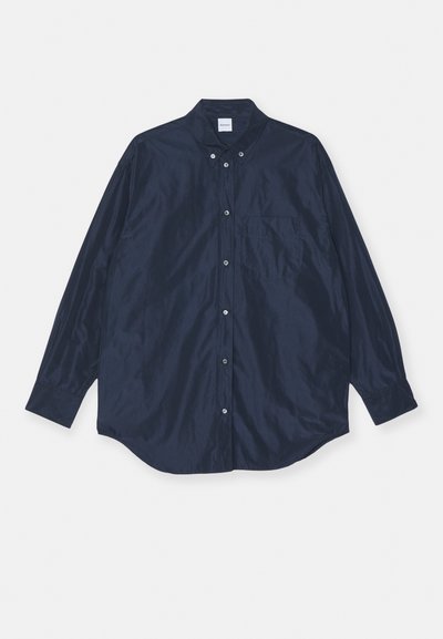 Navy blue long-sleeve button-up shirt, satin-like texture, includes single chest pocket and rounded hem. Features buttoned collar and cuffs.