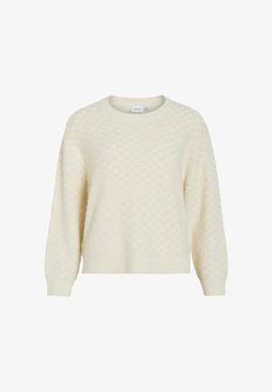 Krēmkrāsas džemperis ar fakturētu medus kārtojuma rakstu, apaļu kakla izgriezumu un ribotu aproču un apakšmalu. Izgatavots no mīkstas adītas auduma.