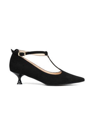 Czarne zamszowe buty na obcasie w stylu T-strap z ostrym noskiem, posiadające mały, rozszerzający się obcas oraz złotą klamrę na pasku wokół kostki.