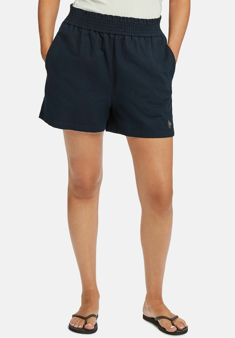 Námořnické kraťasy s elastickým pasem a bočními kapsami, vyrobené z lehkého materiálu, s malým vyšitým logem na lemu.