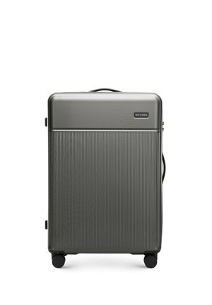 Hard-shell suitcase in dark gray with vertical ribbed texture. Features a top handle, zipper closure, and four black wheels for mobility.