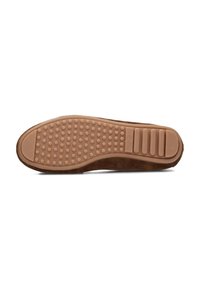 Brown suede shoe sole with a textured rubber grip. Features a smooth finish and small circular dimples for traction.