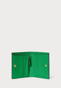 Grønn lærplånbok med gullakenter, med flere kortspor, en glidelåslomme til mynter og et glatt, teksturert indre.