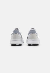 Men's sneakers featuring a white upper with grey accents, textured mesh overlay, and a cushioned white sole. Rear view highlights stitching detail.