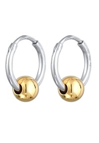 Silverhänge med glatta guldbollar i mitten, som visar upp en kontrasterande metallfinish och en minimalistisk design.