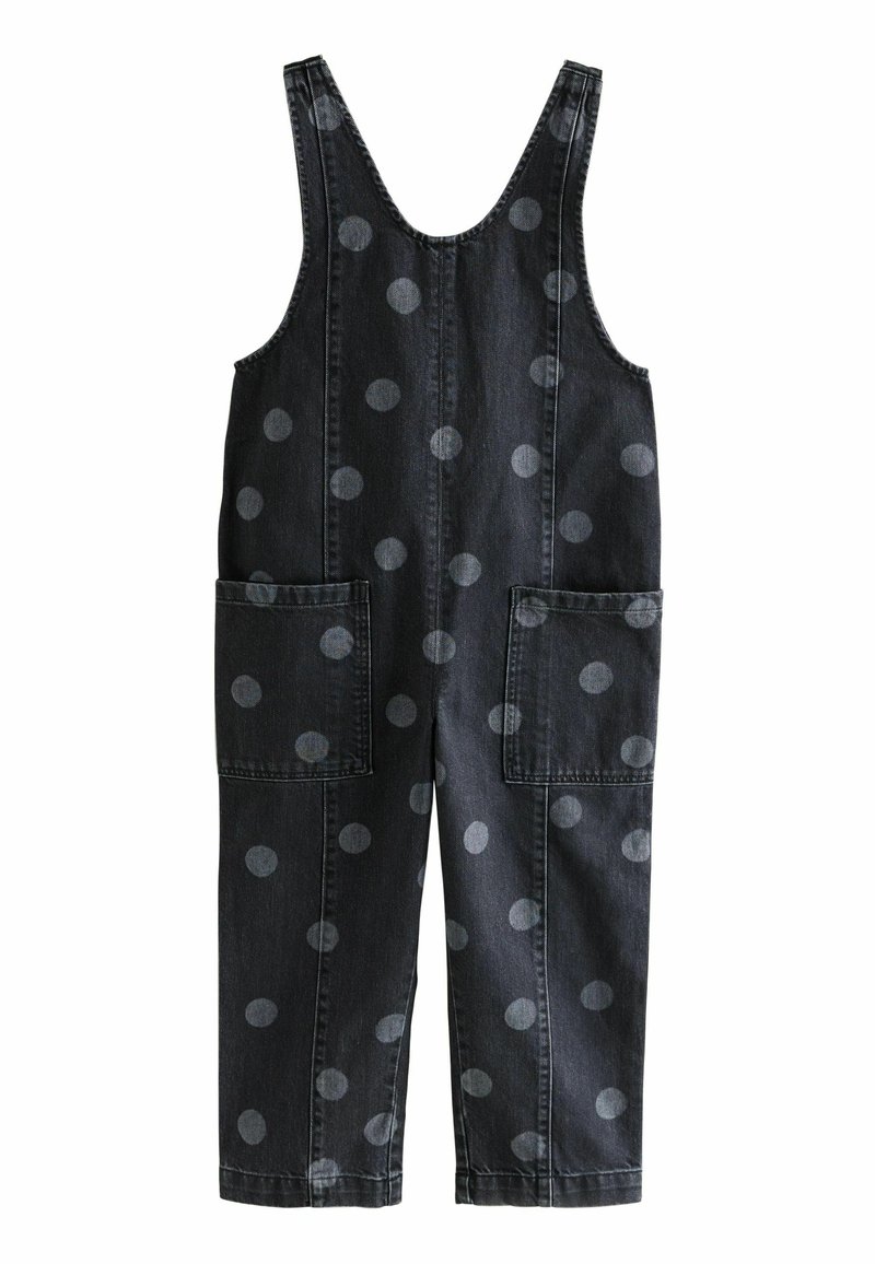 Pantalones de mezclilla en gris oscuro con grandes lunares en gris claro. Presentan tirantes anchos, dos bolsillos frontales y un diseño de pierna recta.