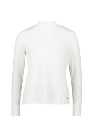 Biała bluzka z długim rękawem wykonana z prążkowanej tkaniny, z półwysokim kołnierzem i falbaniastym dołem. Posiada małe czarne logo po dolnej stronie.