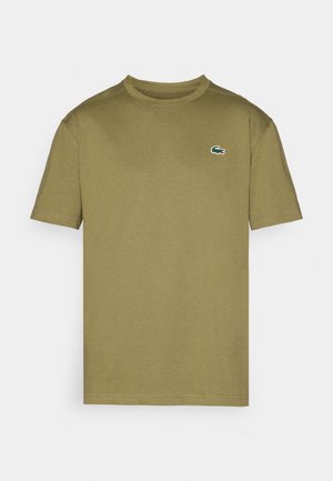 Olivgrünes Baumwoll-T-Shirt mit kurzen Ärmeln, geripptem Rundhalsausschnitt und gesticktem Krokodil-Logo in Weiß und Grün auf der linken Brust.
