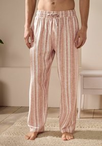 Pantalons de pyjama légers à rayures dans une teinte douce de pêche avec des rayures blanches, dotés d'une taille élastique et d'un cordon de serrage, coupe décontractée.
