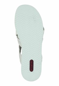 Semelle en caoutchouc blanche avec des crampons en zigzag, dotée d'un logo central rouge. La structure de la chaussure comprend des sangles latérales pour le soutien.