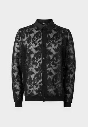 Schwarze Spitzenstrickjacke mit floralem Muster, durchgehendem Knopfverschluss und einfarbigem schwarzen Kragen und Bündchen. Leichtes, transparentes Material.