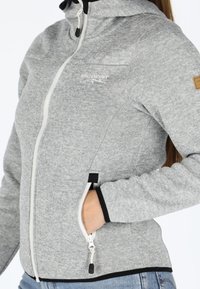 Gray zip-up jacket with a textured finish, white zipper, and black accents. Features a hood and side pockets with black trim.