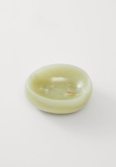 Pale green stone dish with an oval shape, smooth texture, and shiny surface. Small orange inclusion adds a notable detail.