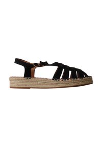 Sandale plate en daim noir avec semelle plateforme en jute tressée et bride à boucle à la cheville, bout ouvert avec plusieurs brides sur le pied.