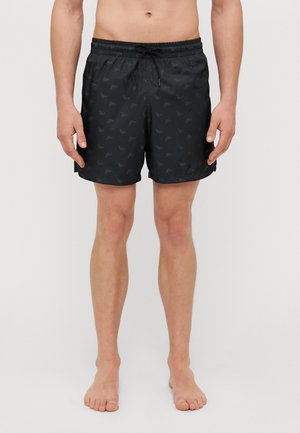 Shorts de bain noirs avec un motif subtil, taille élastique et cordon de serrage. Fabriqués en matériau léger, ils atteignent la mi-cuisse en longueur.