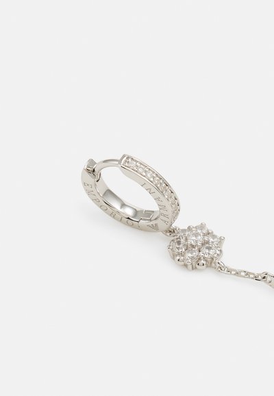 Silver hoop earring with a chain, featuring a floral cluster design adorned with clear gemstones, engraved with "Emporio Armani."