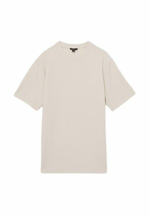 Tricou scurt din bumbac de culoare bej deschis, cu mâneci scurte, fabricat din material texturat, având decolteu rotund și croială dreaptă. Design simplu, fără modele sau accente.
