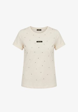 T-shirt beige à manches courtes avec revers roulés, décoré de petits clous brillants et d'un patch logo rectangulaire noir "LIU·JO" sur la poitrine.