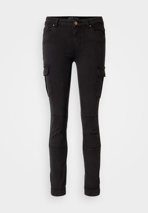 Black cargo pants made of sturdy fabric, featuring side pockets, tapered legs, knee paneling, and elastic cuffs at the ankle.