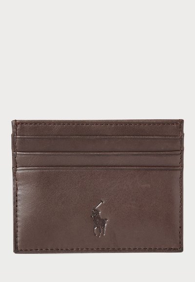 Brown leather cardholder with embossed logo, four card slots, smooth texture, minimalist design, and stitched edges.