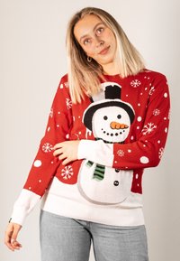 Red sweater featuring a snowman design with a black hat, orange carrot nose, and green scarf, accented by white snowflakes and dots.