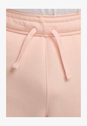 Pantalones de chándal rosa claro con tejido texturizado, cintura elástica y cierres de cordón. Se aprecian detalles en las costuras y un acabado suave.