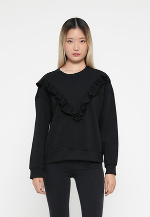 Sweatshirt noir à manches longues avec un détail volant en forme de V le long de l'encolure. Fabriqué en tissu doux avec une coupe décontractée.