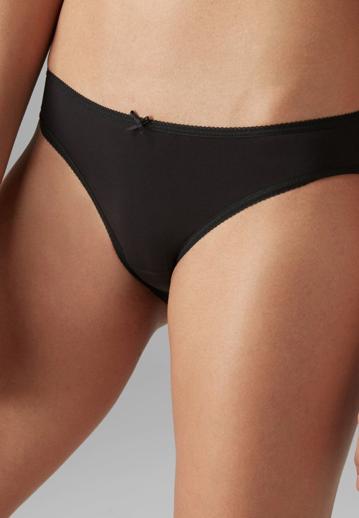 Čierne bikiny vyrobené z hladkej látky, so jemným detailom mašličky vpredu a kontrastnými okrajmi. 