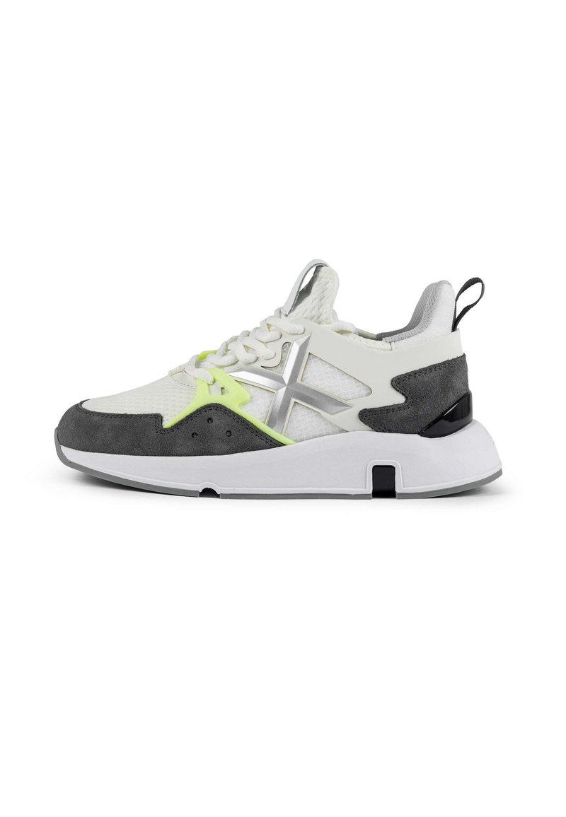 Men's sneaker featuring a mesh and suede upper in white and gray, with neon green accents, a thick sole, and a logo detail.