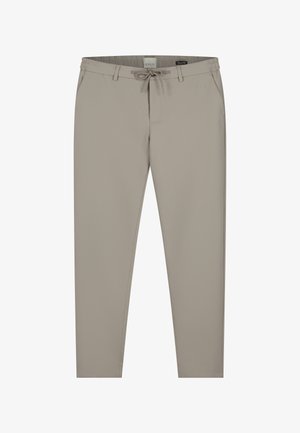 Beżowe spodnie elastyczne w pasie z troczkiem. Posiadają boczne kieszenie oraz zwężający się krój nogawki. Gładka faktura, średni stan.