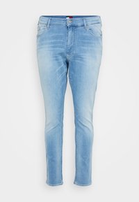 Light blue denim jeans with a slim fit, five-pocket design, and fading detail; features a button closure and belt loops.