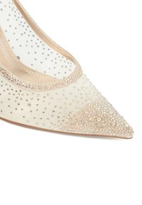 Beige satin pointed-toe pump with beaded embellishments. Features a sheer mesh side panel and light-colored trim along the opening.