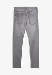 Szürke, skinny farmernadrág sima textúrával, két hátsó zsebbel és normál derékkal. Az anyag enyhén kopott.