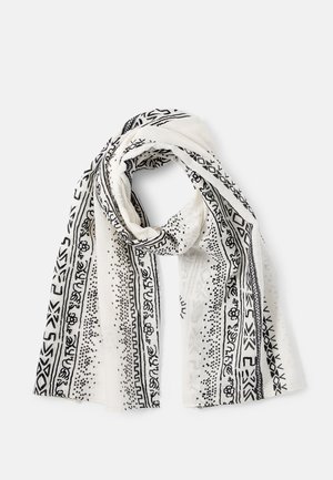 Écharpe blanche avec des motifs géométriques et floraux noirs, pliée librement sur un fond blanc.