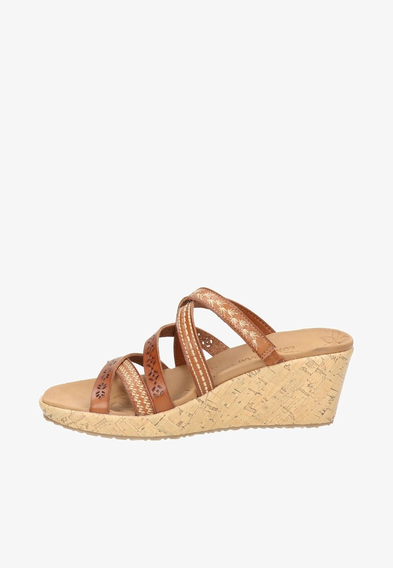 Sandale compensée marron avec semelle en liège, avec quatre brides en cuir décorées qui se croisent sur le pied.