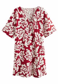 Robe rouge avec grand motif floral blanc, manches courtes, col en V avec détail lacé et coupe décontractée.