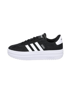 Zapatilla Adidas en blanco y negro con suela blanca, tres franjas blancas en el lateral y logotipo de Adidas en la lengüeta y el talón.