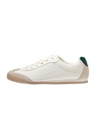 Fehér bőr sneaker világos bézs részletekkel, textúrázott orr résszel és zöld sarkú tabbal, alacsony profilú, fűzős dizájnnal.