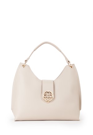 Sac à main en cuir crème avec une anse supérieure arrondie et un fermoir circulaire doré présentant un motif floral découpé centré à l'avant.