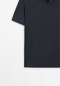 Dark gray short-sleeve polo shirt with a collar, shown on a white background, focusing on the upper body area.
